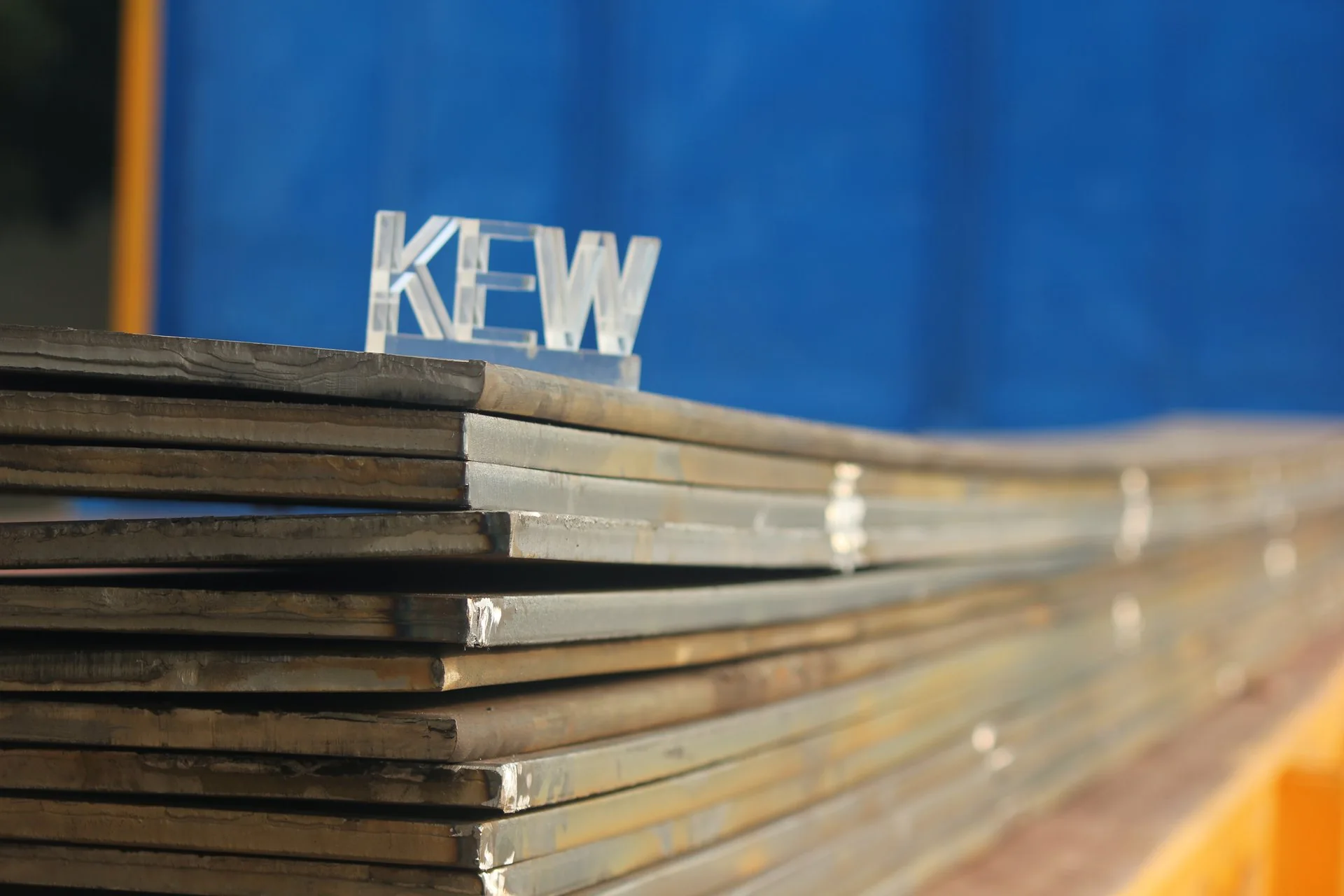 Stacked heavy steel plates at the KEW workshop